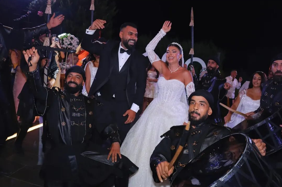 Newlyweds celebrating with traditional zaffe performers